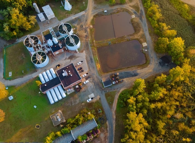 An aerial view of a US farm showcasing several anaerobic digester systems. The image highlights the integration of digesters within the farm's infrastructure, presenting a sense of scale and technological application in agriculture.