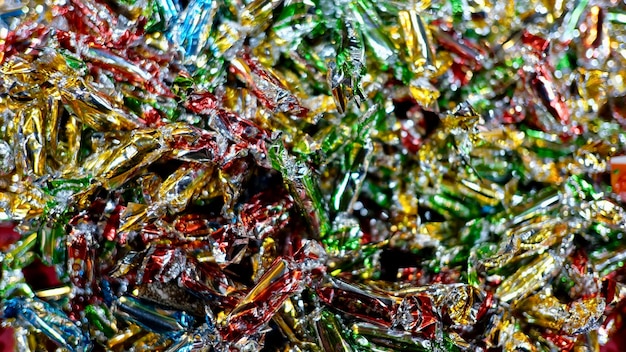 A close-up shot of different types of recycled materials (plastics, metals, paper) being sorted at a recycling facility. The materials are clean and well-organized, and workers are visible in the background, ensuring quality control.