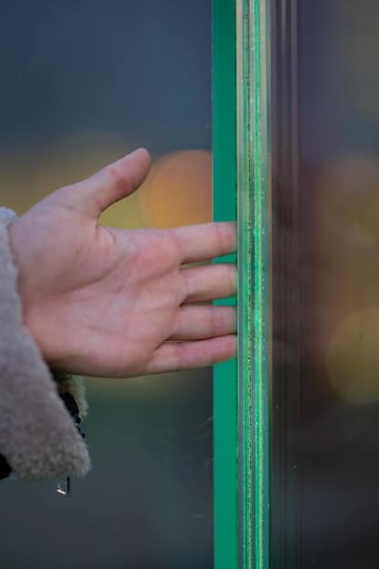 A close-up of smart window film on a window, demonstrating its ability to tint or become transparent to regulate sunlight and temperature.