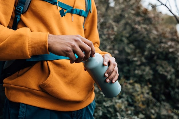 An image of a traveler hiking through a national park, wearing sustainable clothing and carrying a reusable water bottle, emphasizing eco-friendly practices.