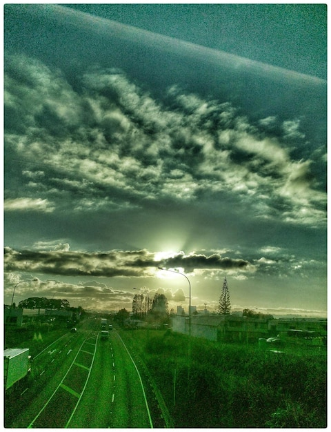 A split image showing two contrasting scenes. On one side, a polluted industrial area with smog and smoke stacks. On the other side, a clean, green city with electric cars and solar panels.